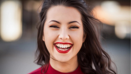 Mujer morena sonriendo.