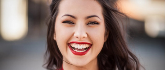 Mujer morena sonriendo.