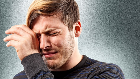 Hombre joven llorando.